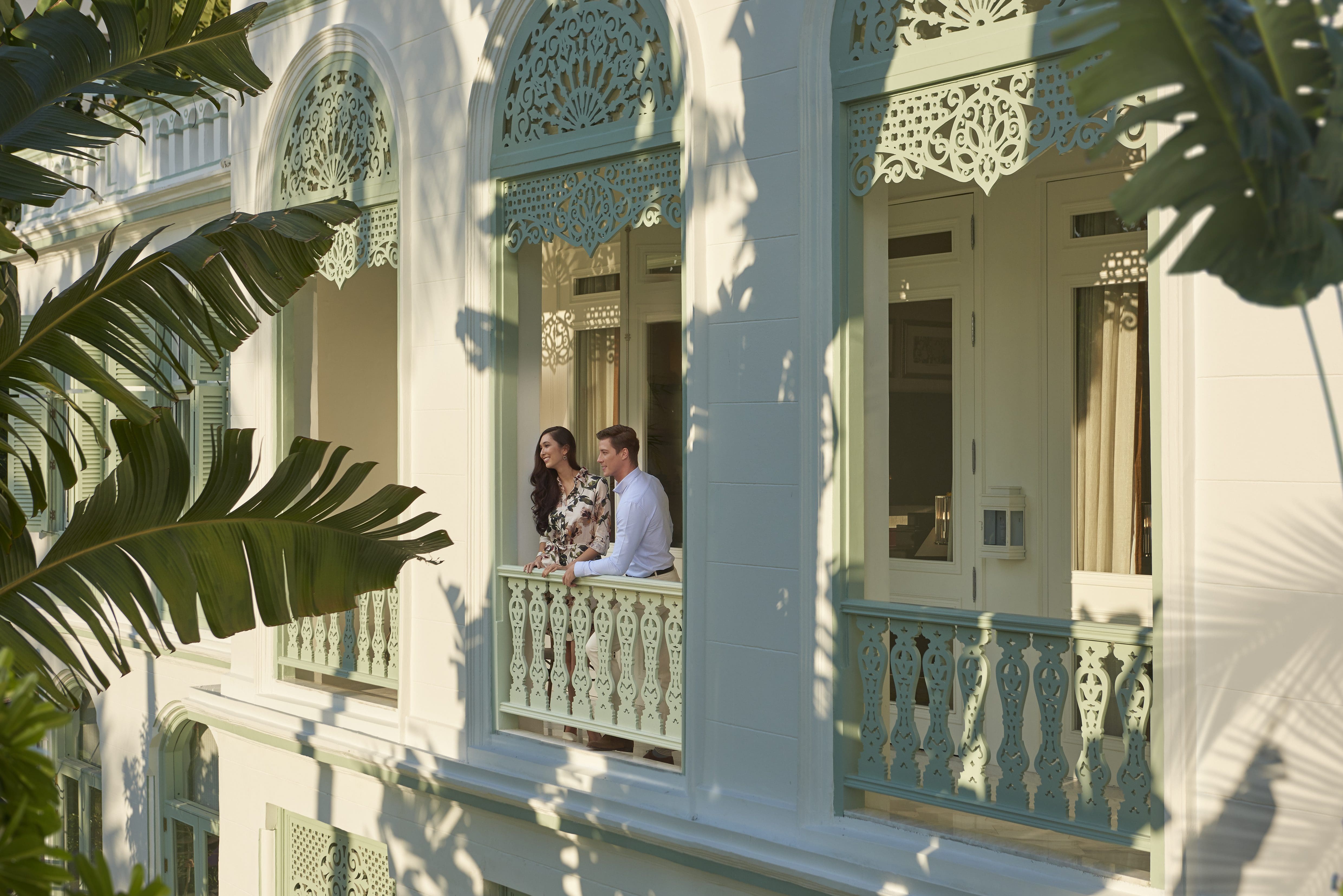 a couple standing at balcony
