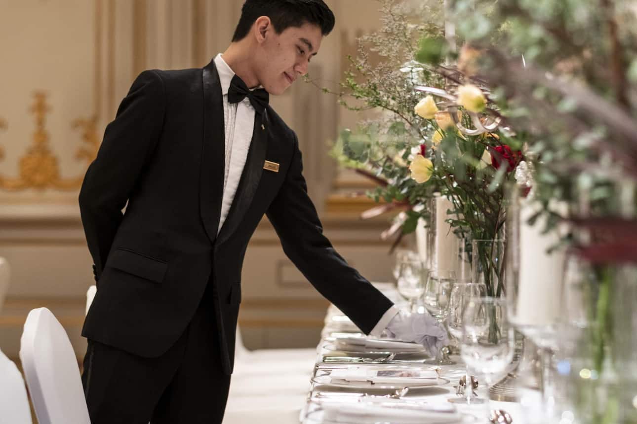 Waiter setting a wedding banquet table