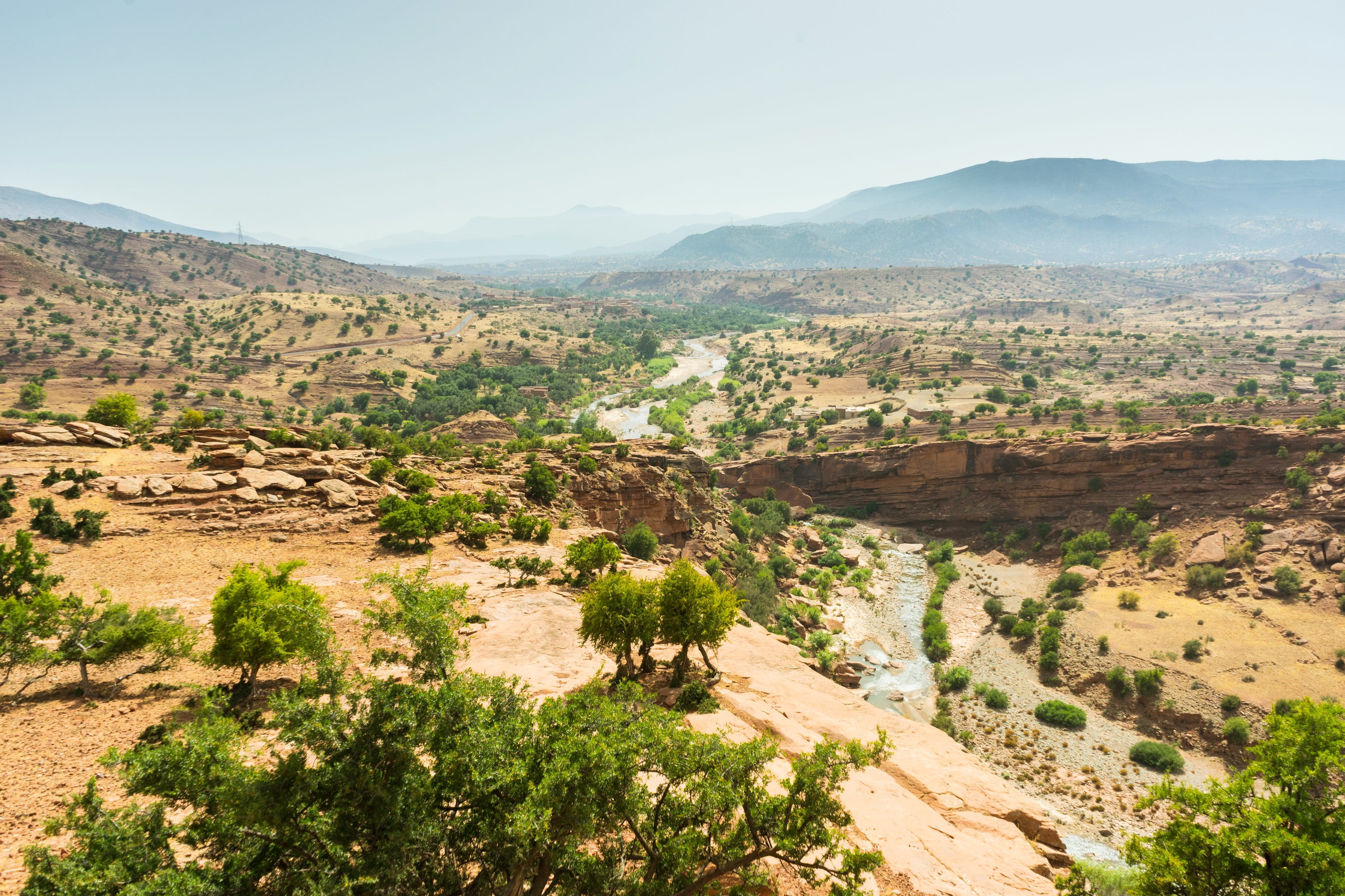 Arid mountains of Morocco with green trees dotted around