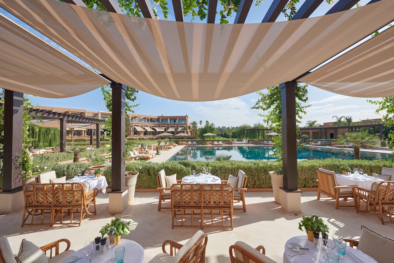 Tables set up for alfresco dining in the Pool Garden restaurant at Mandarin Oriental, Marrakech