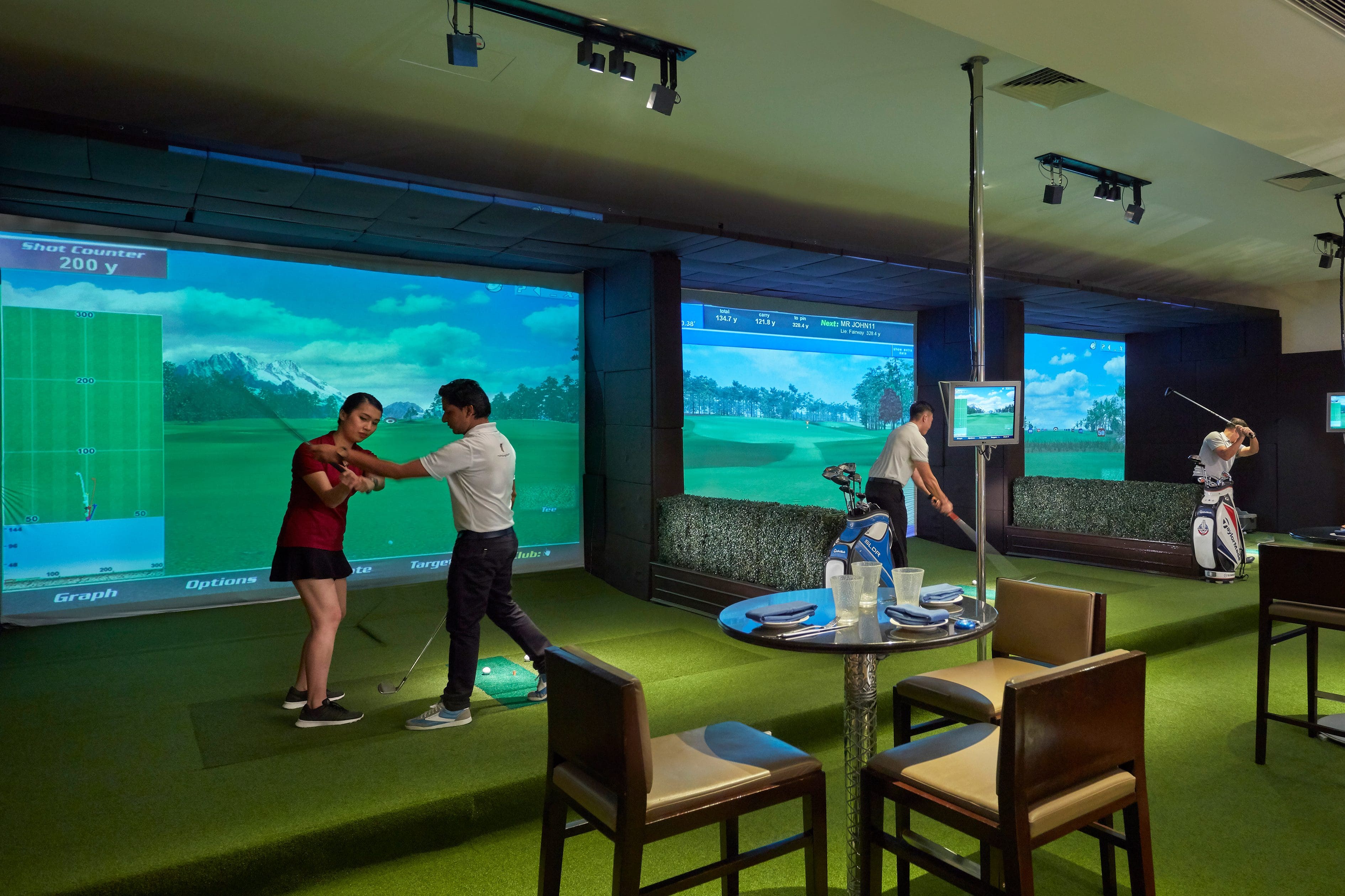 Visitors take a swing at Kuala Lumpur’s indoor golf academy and simulator