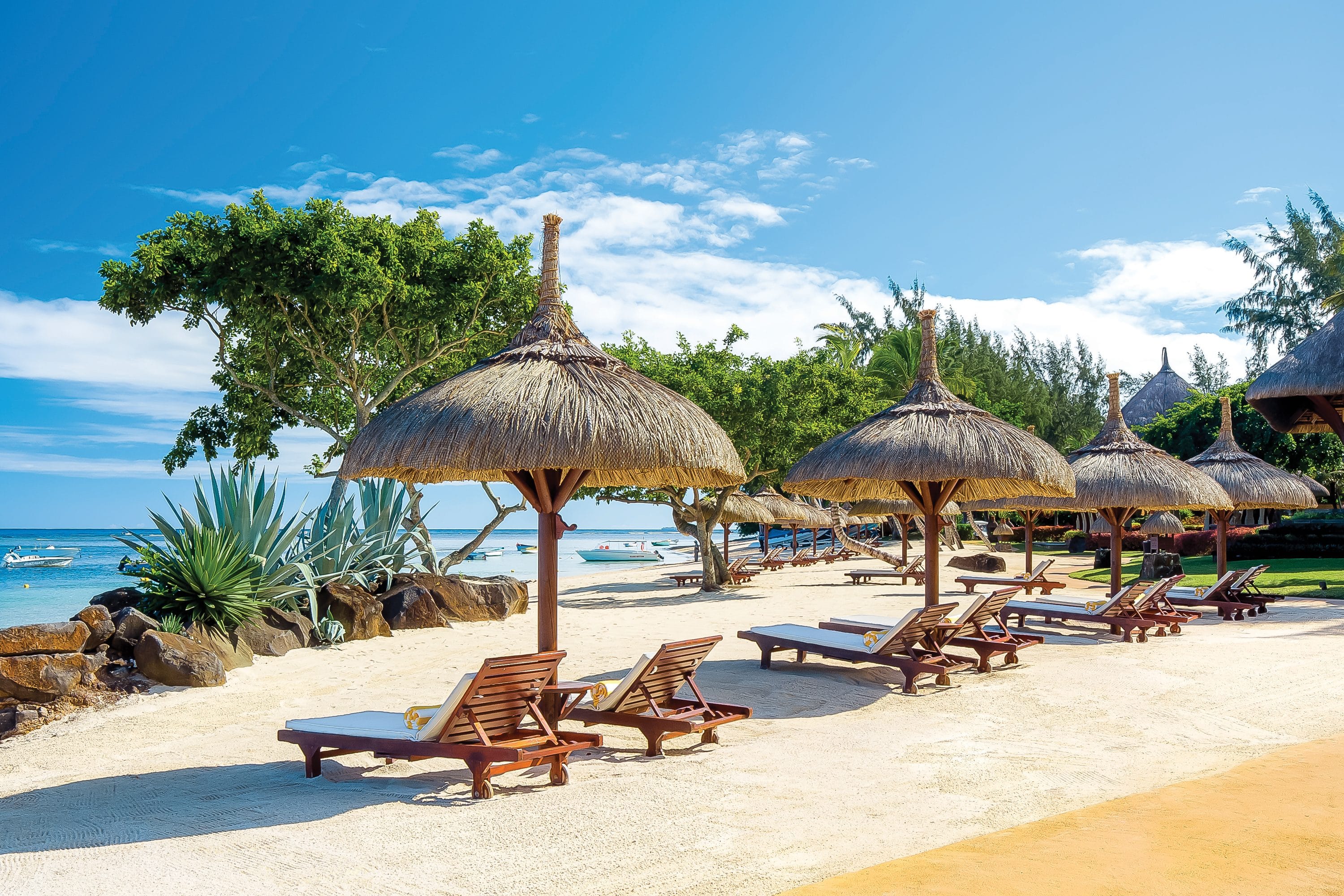 Sun loungers and umbrellas on beach in Mauritius