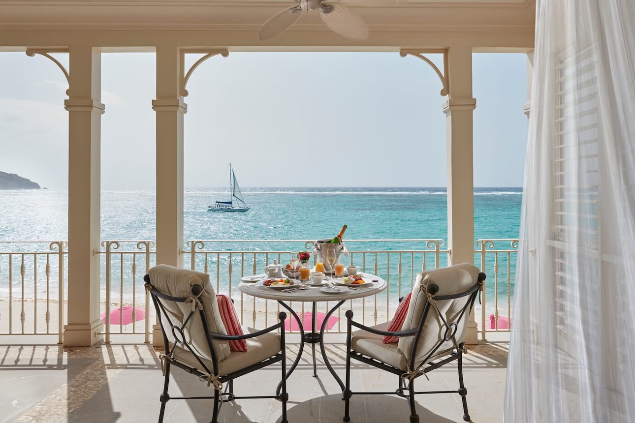 A table and chairs set up for breakfast on a private terrace with sea views