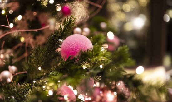 Pink, festive baubles on Christmas tree