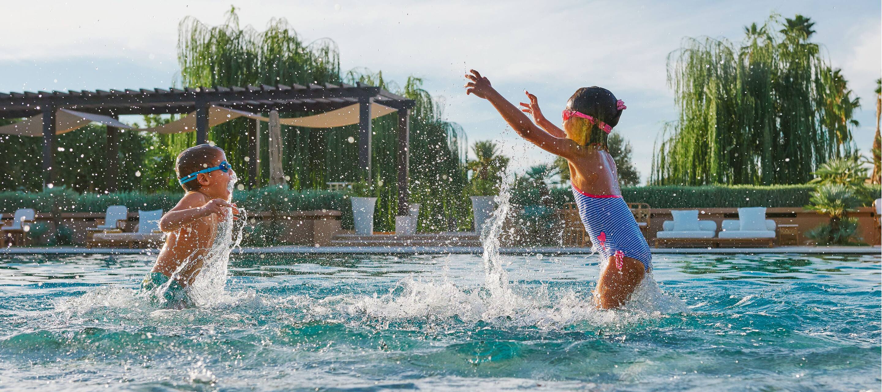 Two children splash about in the swimming pool at Mandarin Oriental, Marrakech