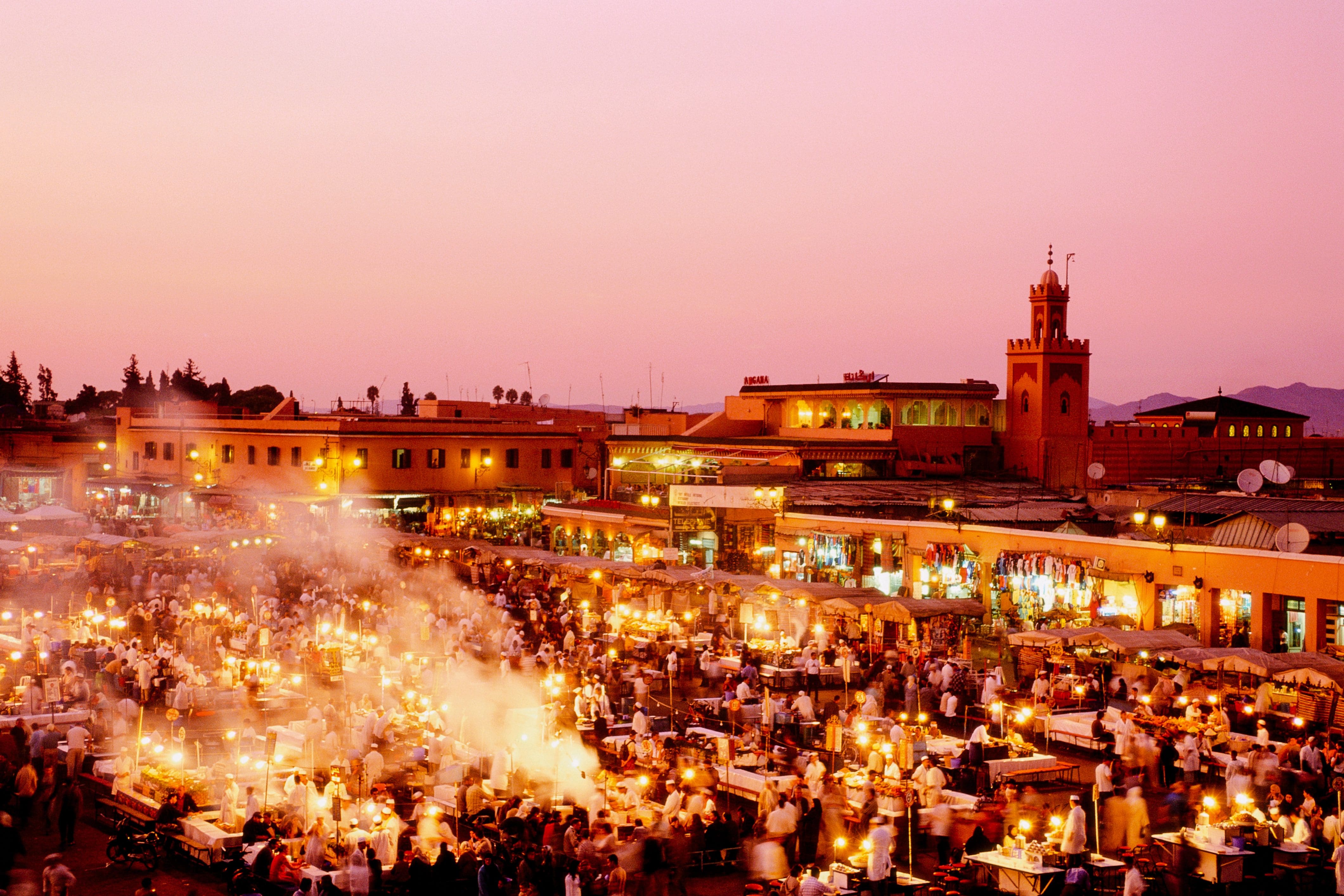 The Jemaa el-Fnaa by evening busy with market stalls, traders and shoppers