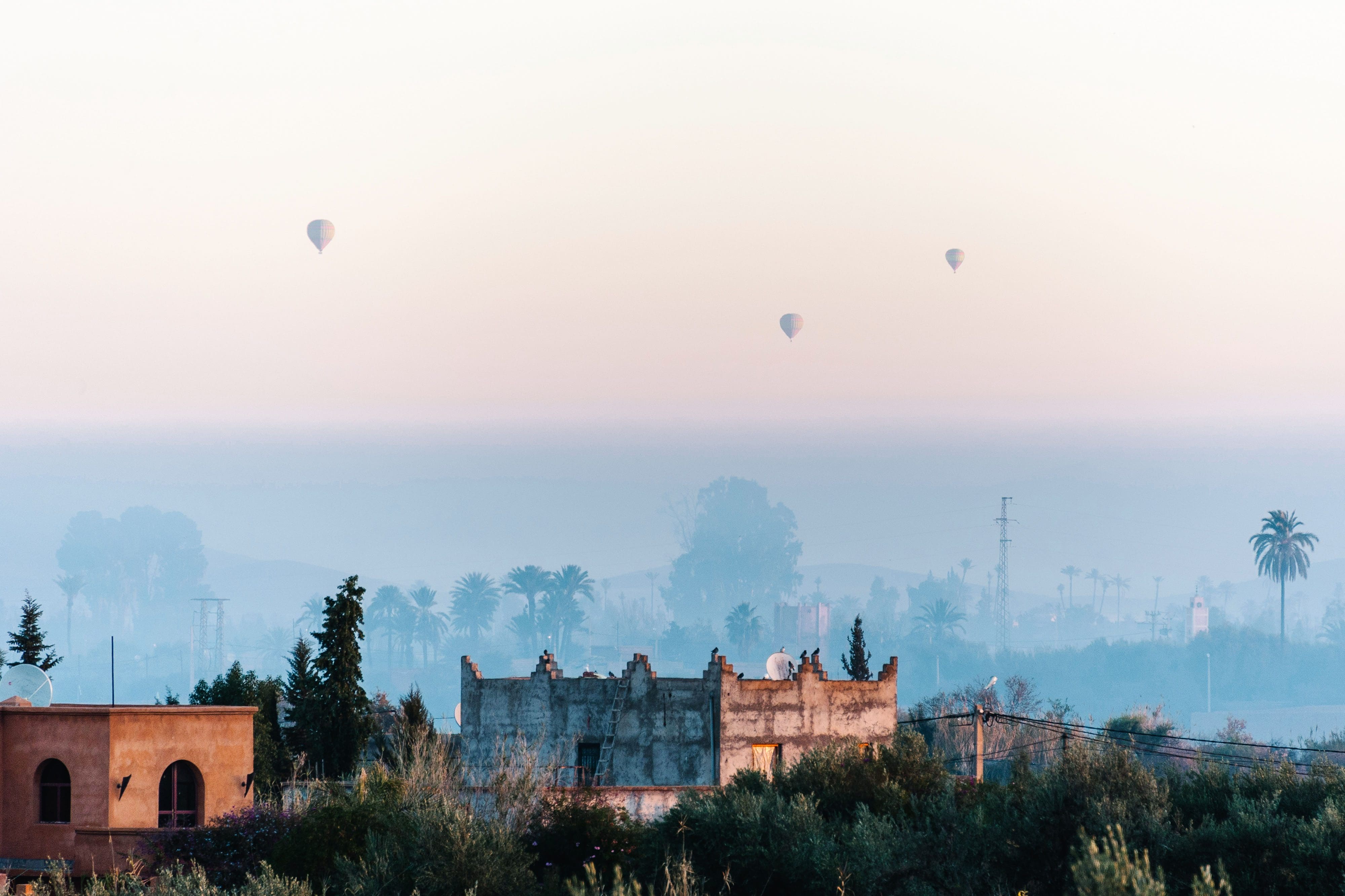 Hot air balloons float over a mist Marrakech