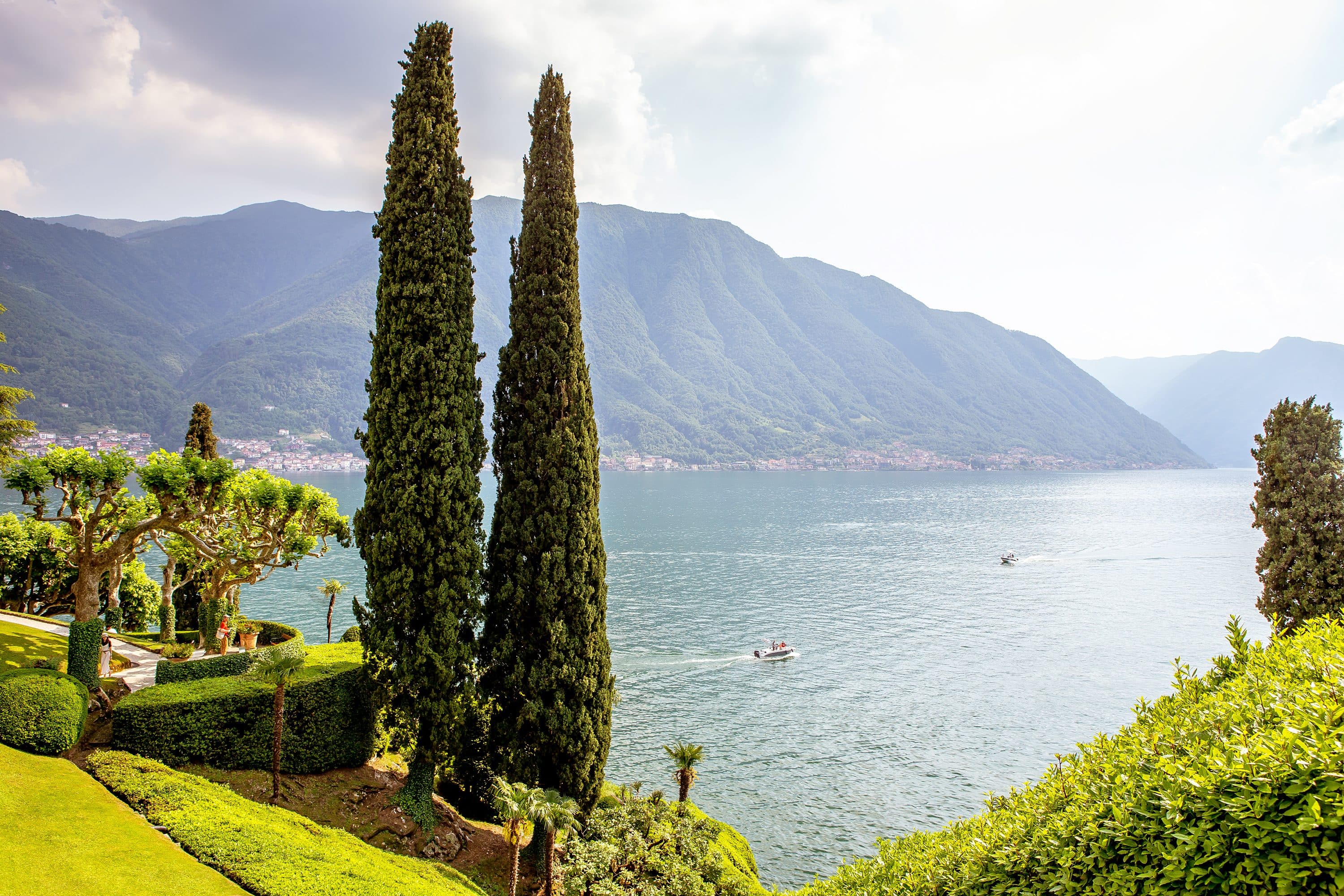 Verdant gardens and trees line the waters edge at Bellagio, Lake Como