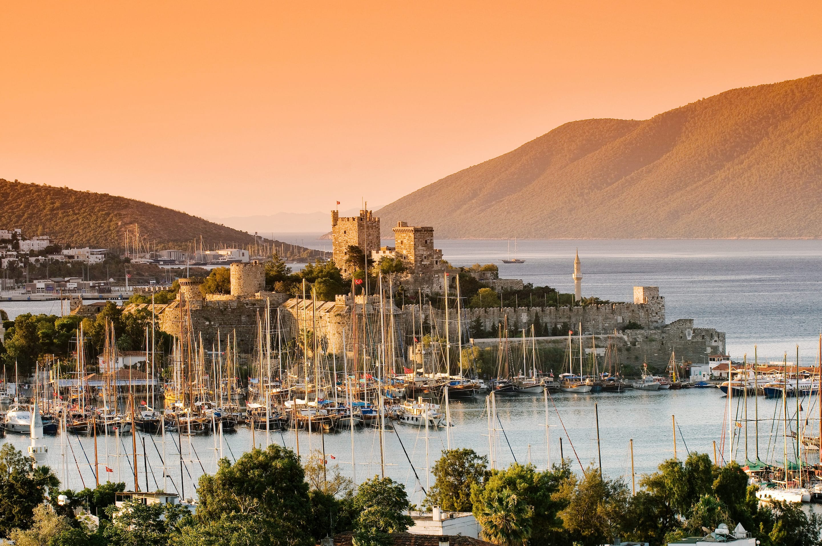 Magnificent Bodrum Castle surrounded by boats at sunset 