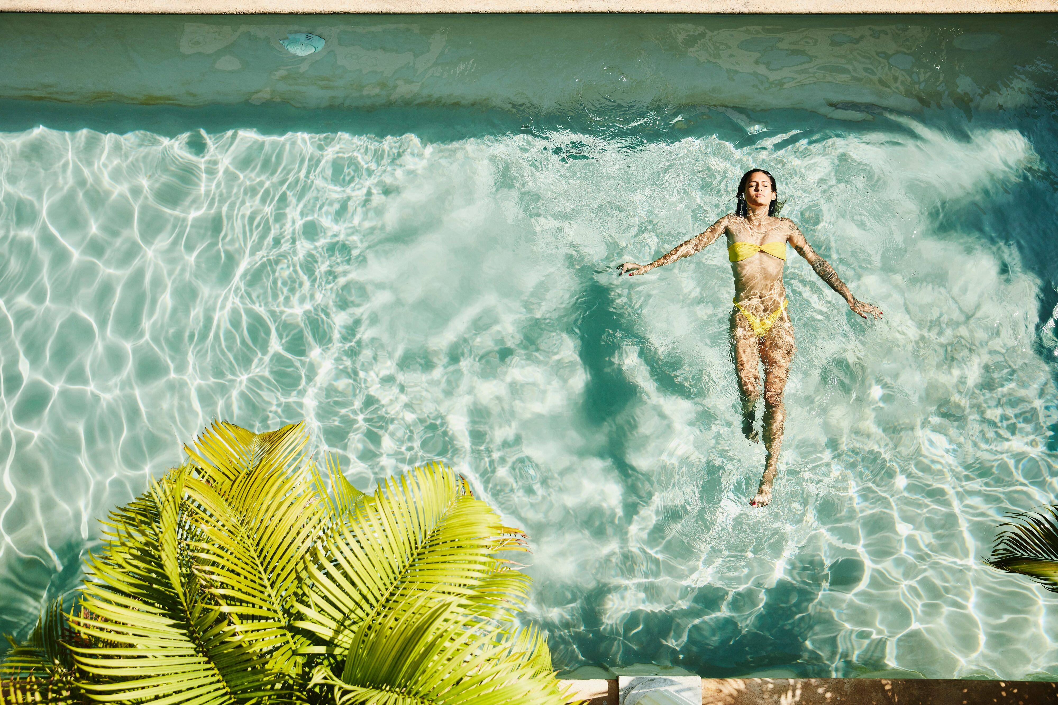 Woman relaxing in a swimming pool 