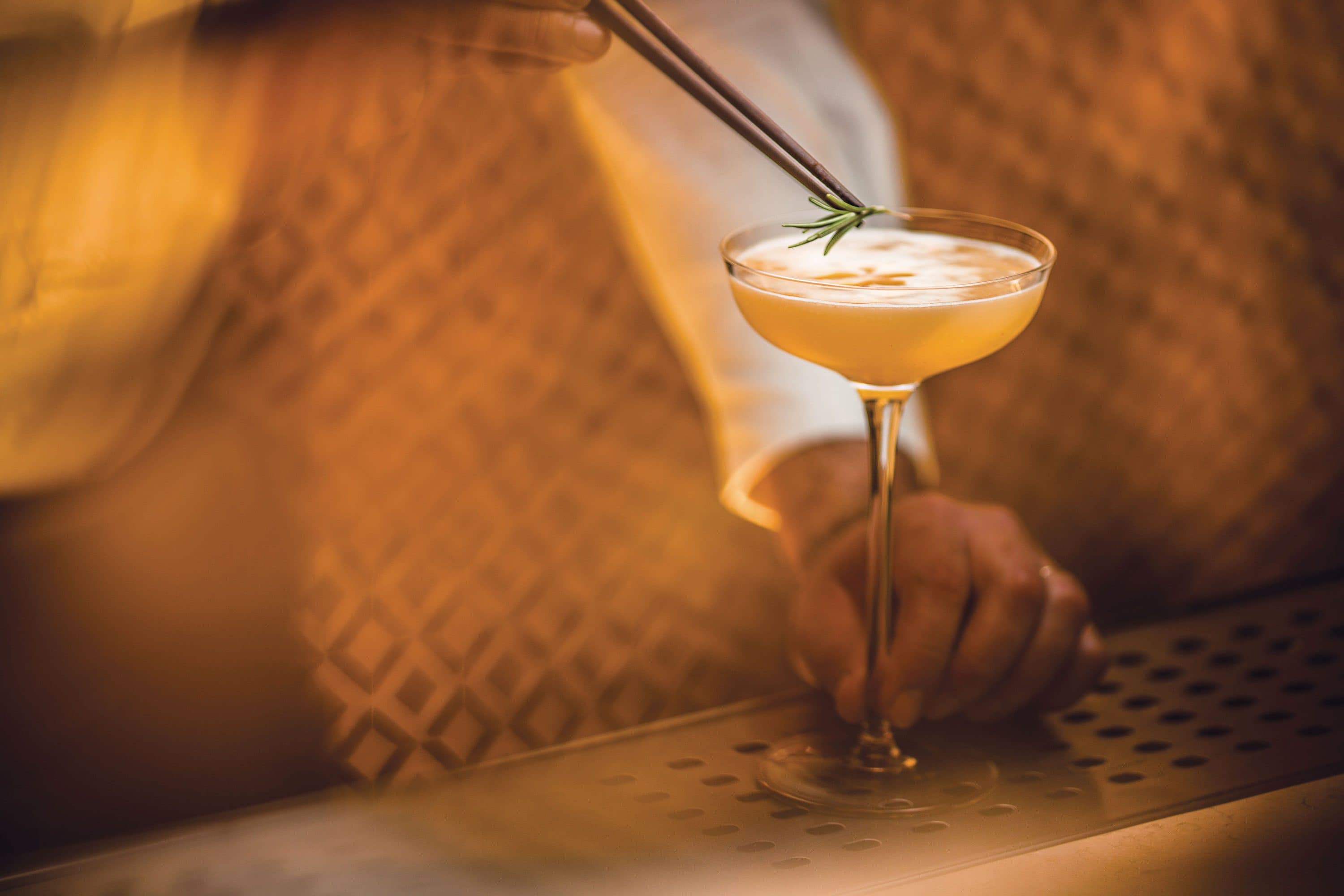 Mixologist serving a cocktail 