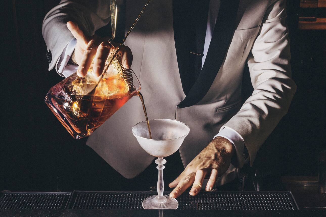 Mixologist serving a cocktail