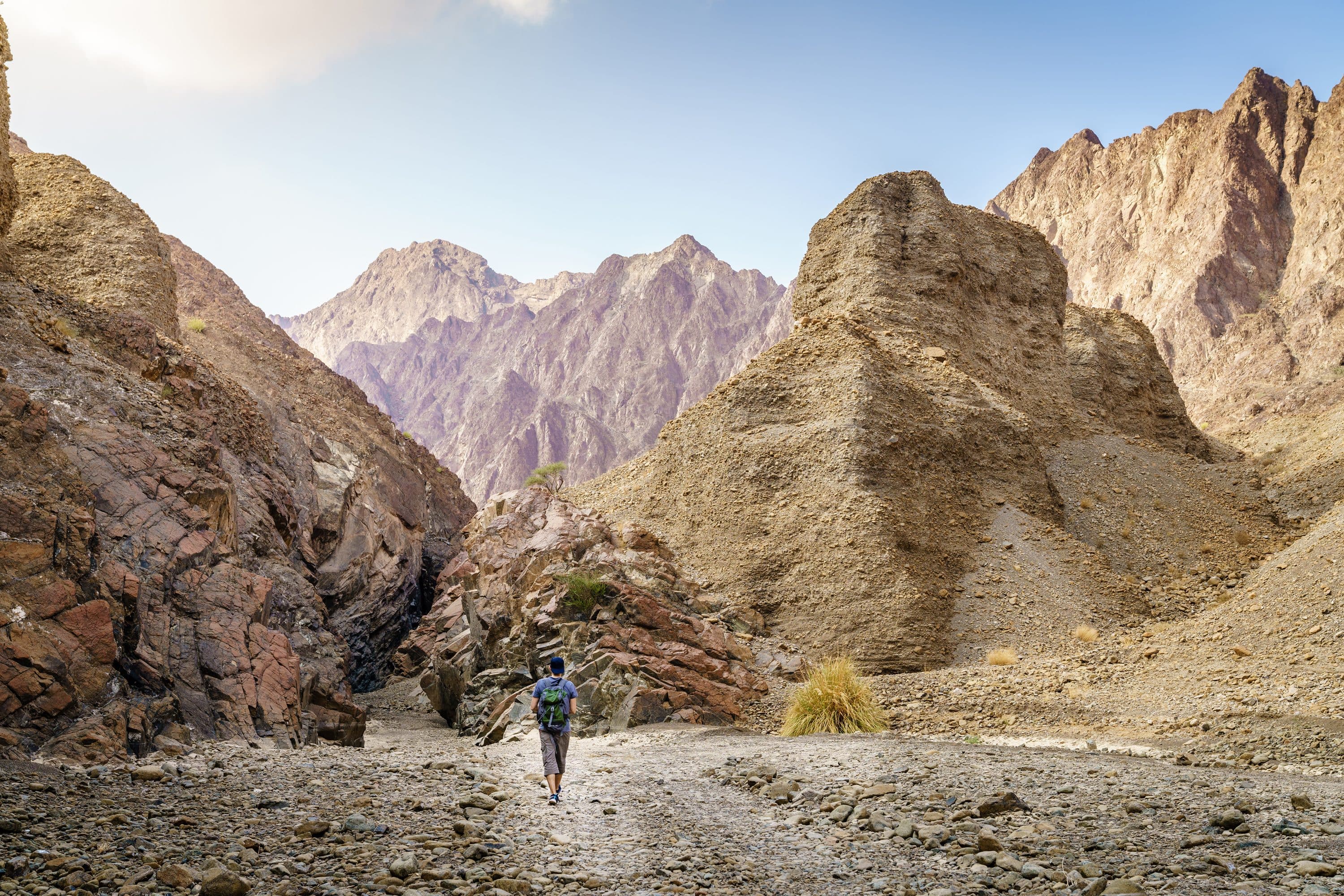 Man hikes through mountain pass of the Hatta Trails, Dubai