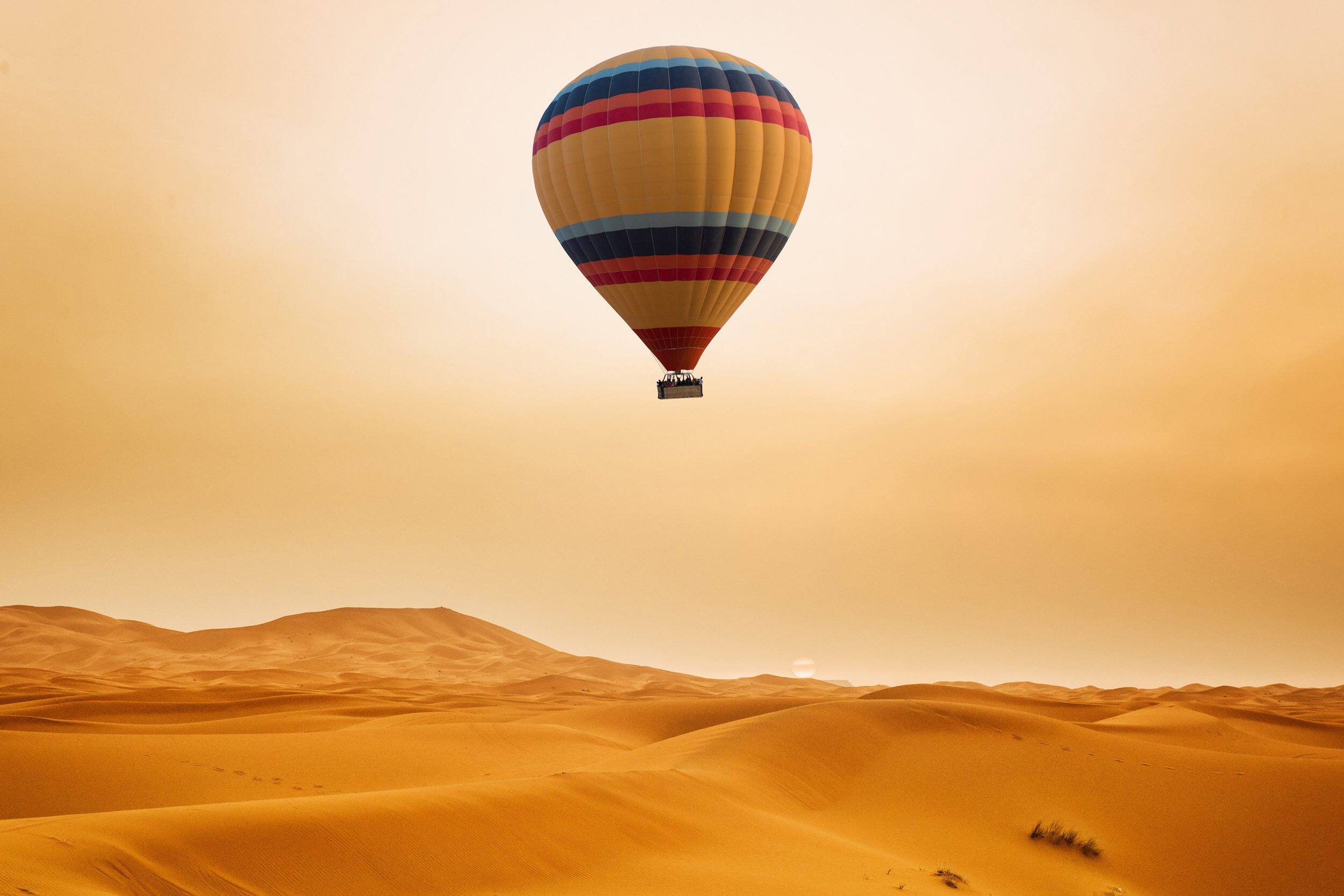 A hot air balloon floating over the Dubai desert