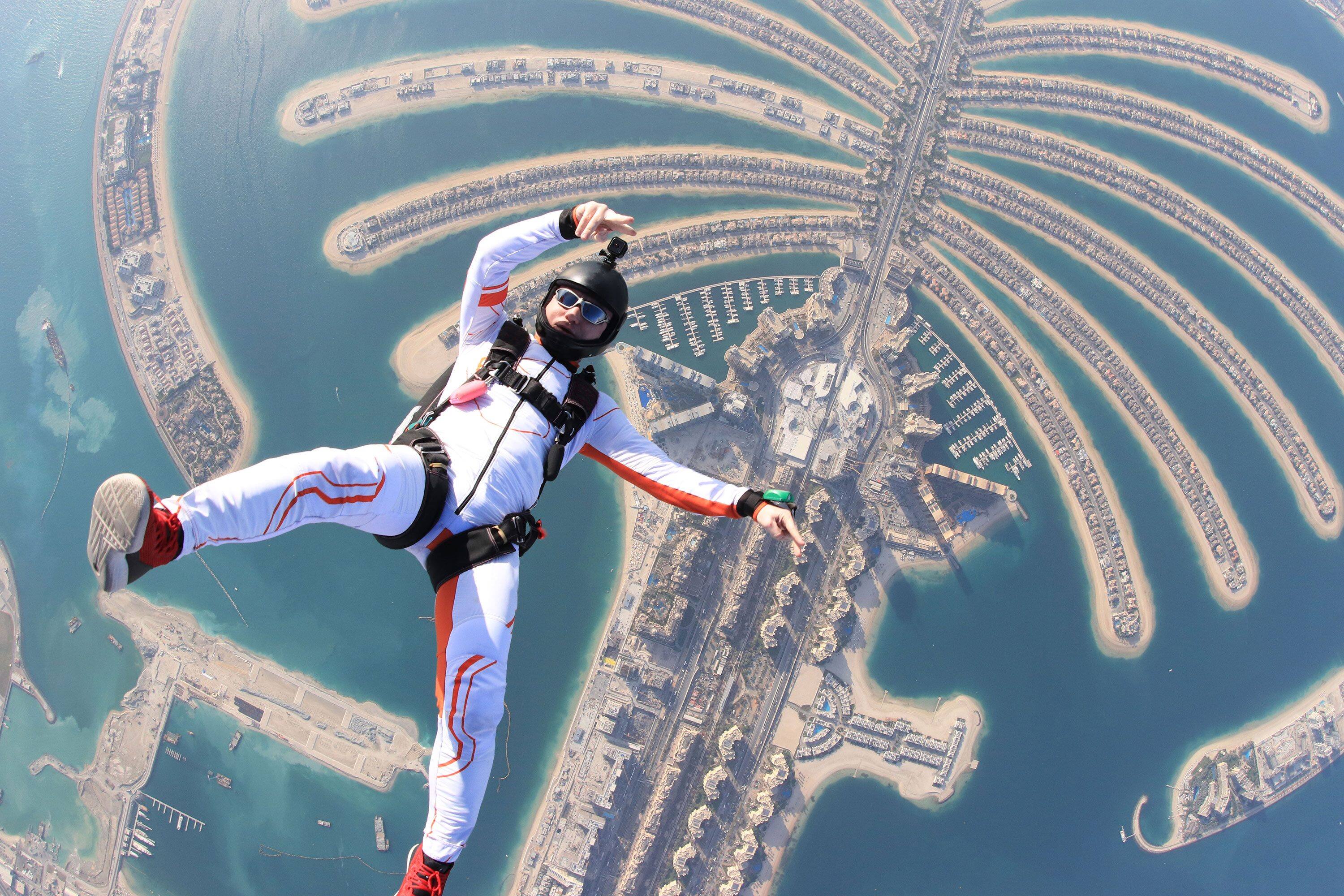 A skydiver falls against the backdrop The Palm Jumeira archipelago in Dubai