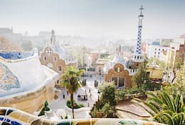 A view of Barcelona from the colourful tiled Park Güell by Gaudí, Spain