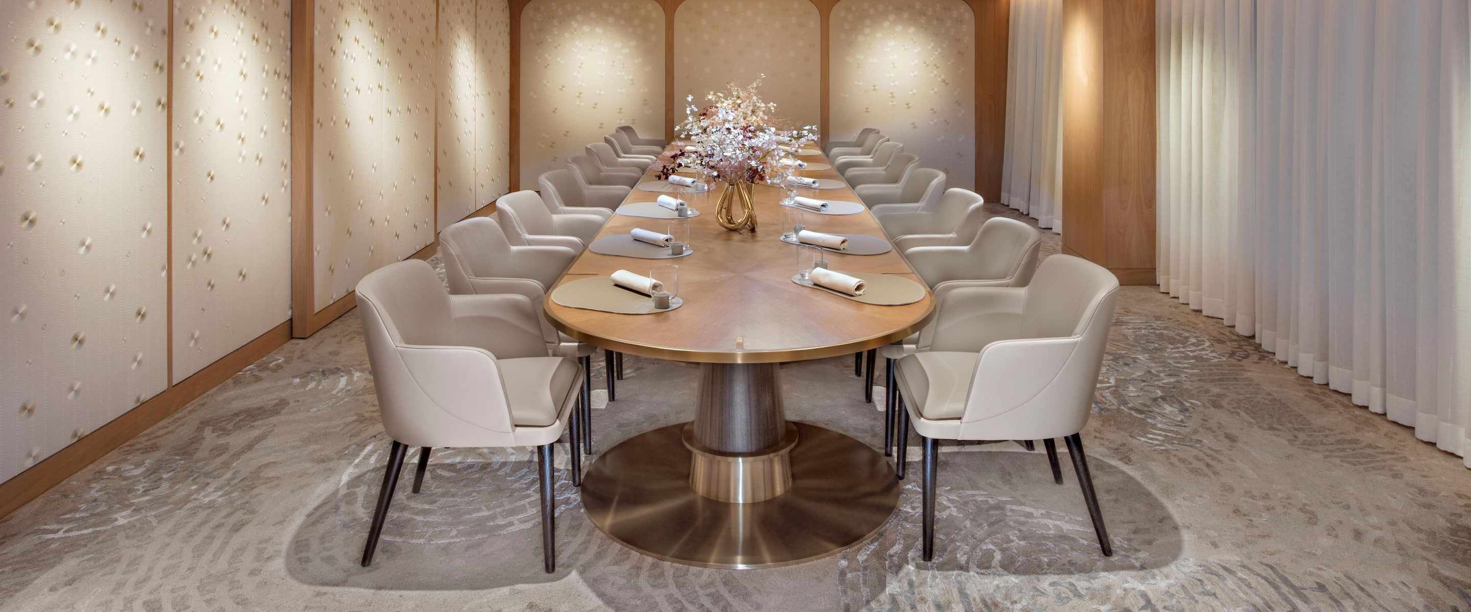golden lit private dining room with long table surrounded by chairs