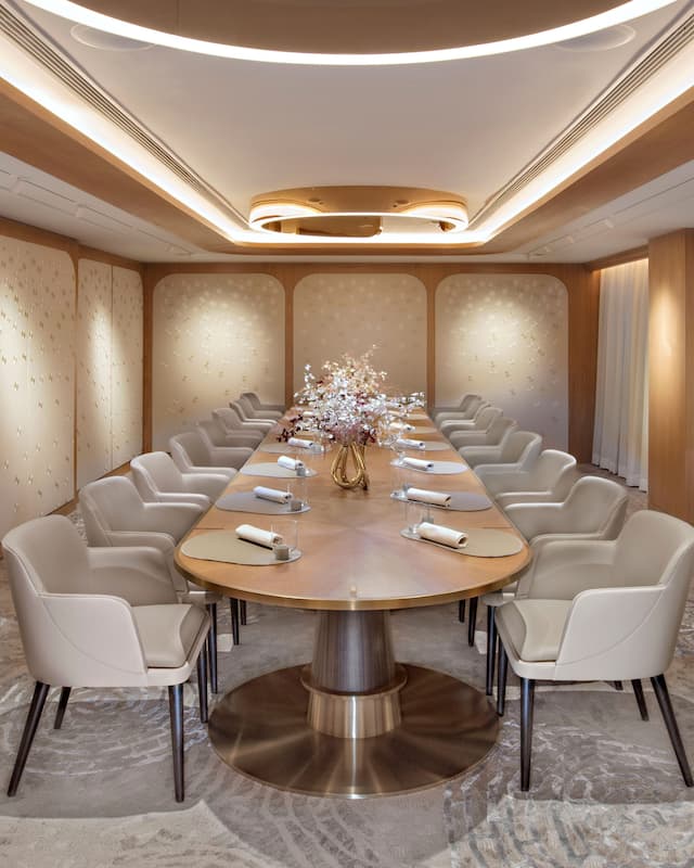 golden lit private dining room with long table surrounded by chairs