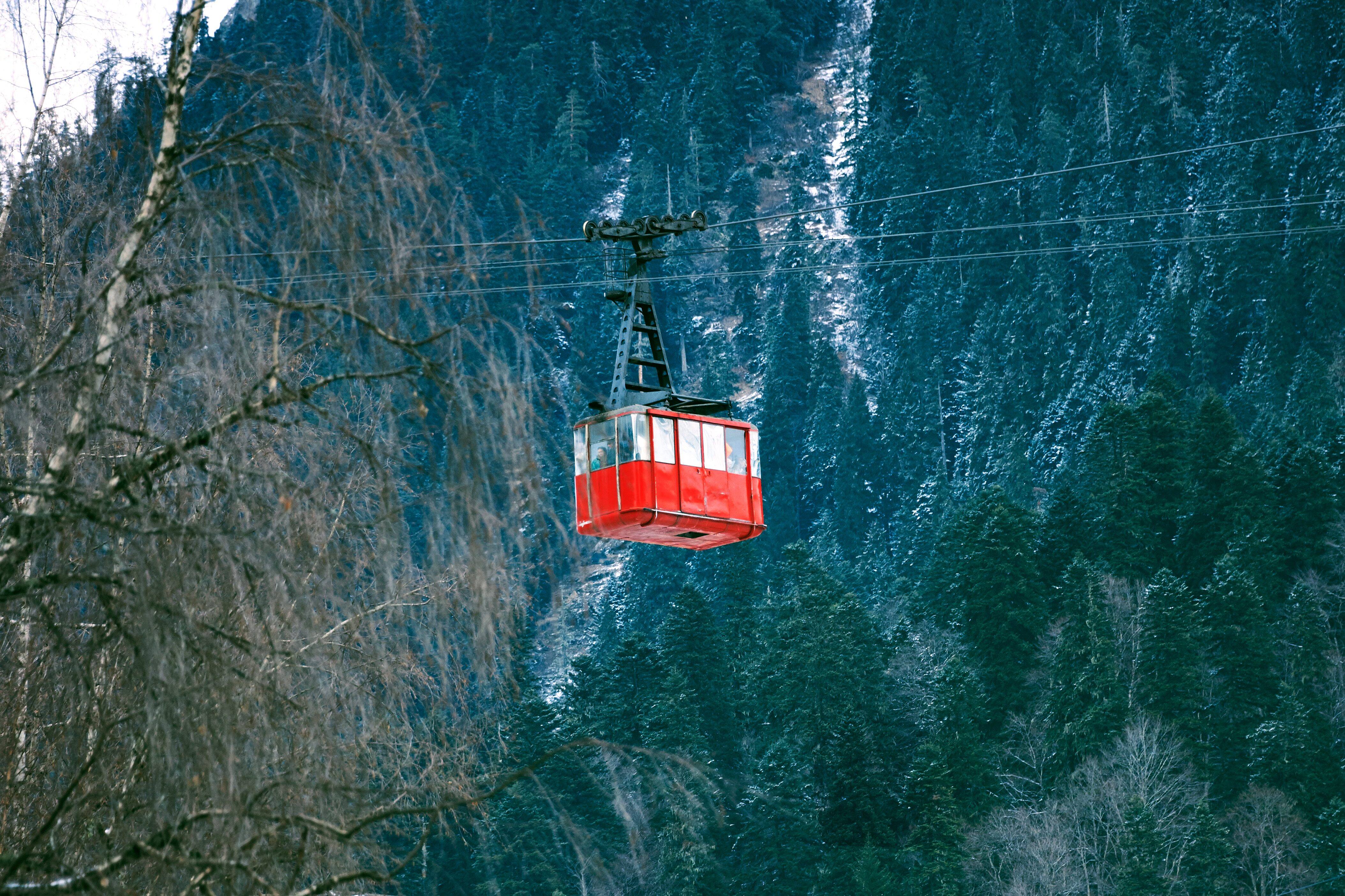 Cable car moving in front of a stunning mountain backdrop
