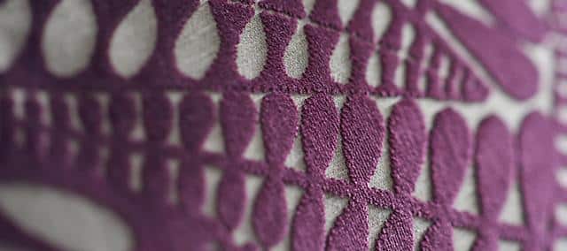 light gray textile with purple triangular pattern