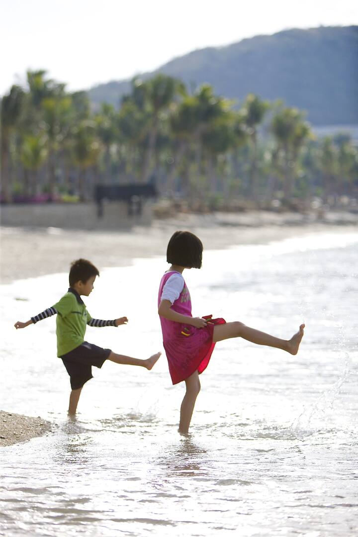 kids playing on beach at mandarin oriental, sanya