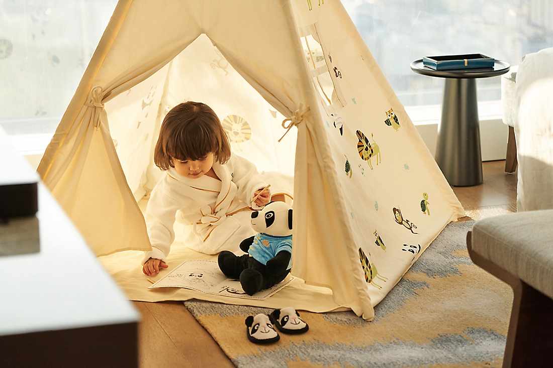 kid playing in tent