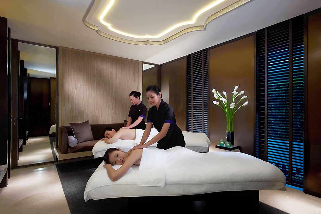 couple getting treatment in spa suite 