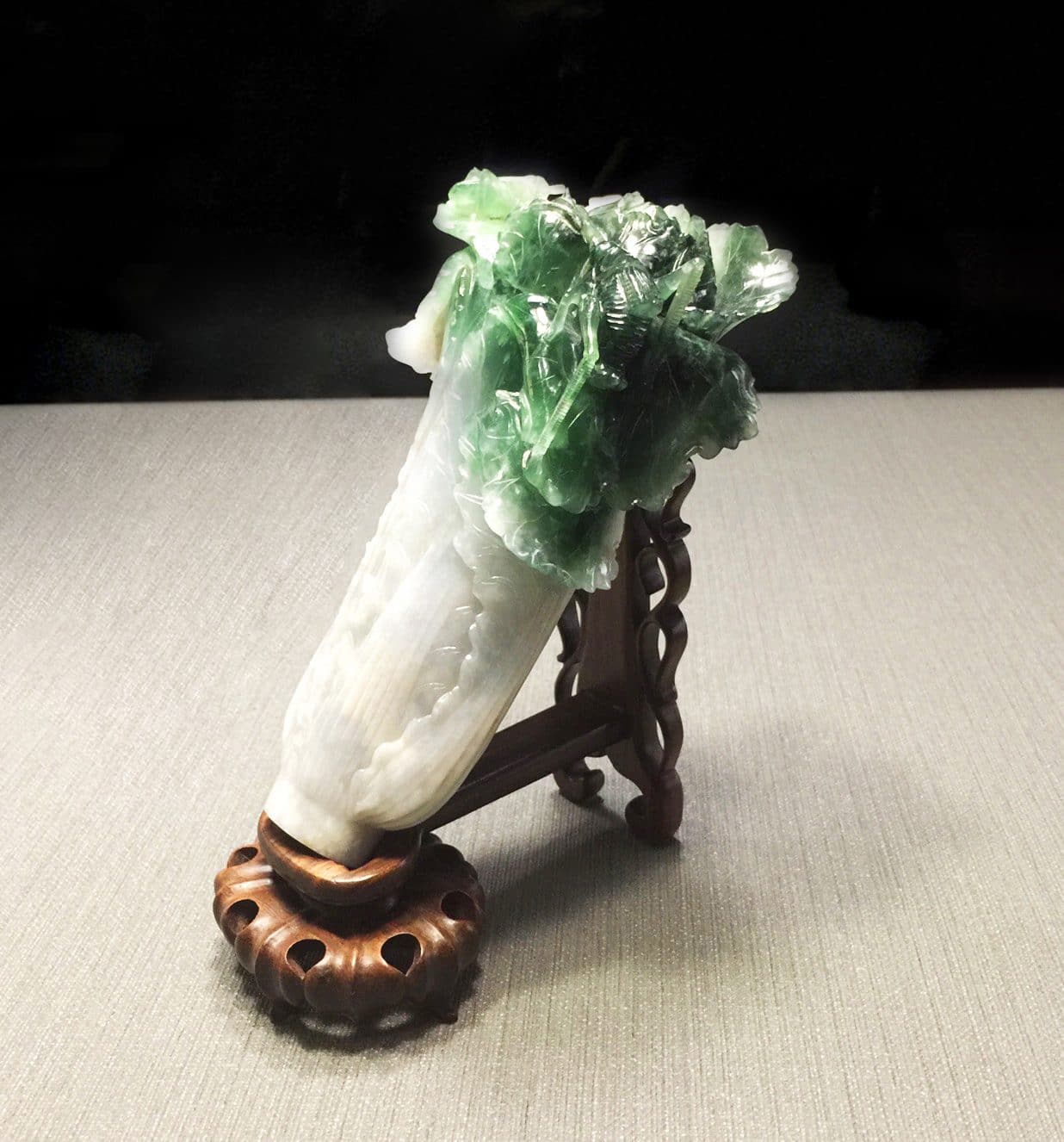 Piece of jade carved in the shape of a cabbage with a grasshopper on it