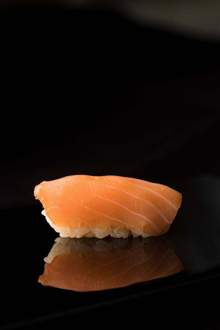 pink fish laid on white rice as sushi